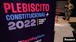 Vojnik na straži u školi koja je mjesto probno glasanje uoči ustavnog referenduma 4. septembra, Santiago, 2. septembra 2022.