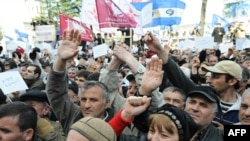 Georgian protesters chant slogans at a rally in Tbilisi on April 10