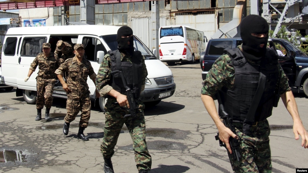  Members of the SNB get out of a minivan during an operation outside the capital, Tashkent, in June 2015.