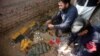 Police go through weapons collected from the bodies of attackers after the shooting at Directorate of Agriculture Institute in Peshawar on December 1.