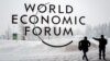 SWITZERLAND -- A security guard show the way to a man outside of the Davos Congress Centre under snow ahead of the opening of the World Economic Forum (WEF) 2018 annual meeting, in Davos, January 22, 2018