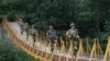 Indian Border Security Force soldiers patrol over a footbridge built over a stream near the Line of Control (file photo).