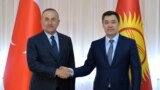 Turkish Foreign Minister Mevlut Cavusoglu (left) shakes hands with Kyrgyz President Sadyr Japarov at their meeting in Bishkek on March 10.