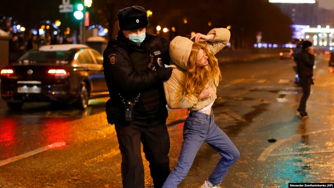Riot police detain a young woman during a protest against the jailing of opposition leader Aleksei Navalny in Pushkin Square in Moscow on January 23.
