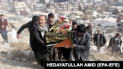 People attend the funeral of one of the victims of a suicide bomb attack in Kabul on January 28. 
