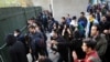 Iranian students clash with riot police during an anti-government protest around the University of Tehran on December 30.