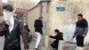 Protestors are affected by tear gas fired by anti-riot Iranian police to disperse demonstrators in a protest in Tehran.