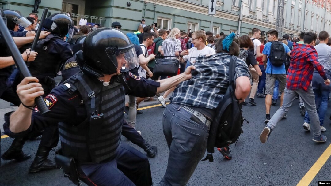 Police chase protesters during a rally against planned increases to the nationwide pension age in Moscow on September 9.