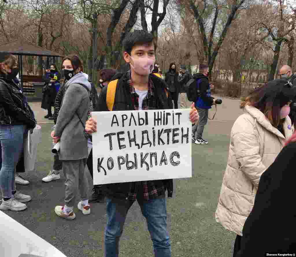 Әйелдер маршын ерлер де қолдады. "Арлы жігіт теңдіктен қорықпас" деген плакат ұстап тұрған ер адам. 