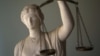 Iran -- A Justice statue is pictured at the office of Masud Shafie, lawyer for the three US hikers charged with spying after they were arrested near Iran's border with Iraq, in Tehran, 09May2011