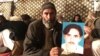 A member of Pakistan's Pashtun community holds a picture of Naqibullah Mehsud, whose extrajudicial killing by Karachi police sparked nationwide protests.