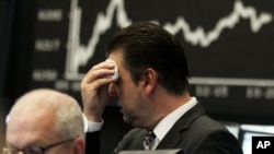 Germany -- Market analyst Robert Halver wipes his face at the German stock exchange in Frankfurt, 05Aug2011