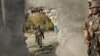 FILE: Afghan soldiers near a hole in a wall made to rescue people from the Shamshad TV building after a deadly attack in Kabul on November 7, 2017.