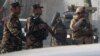 Afghan soldiers block a road near the site of a suicide attack in Kabul on December 25.