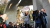 Iranian students clash with riot police during an anti-government protest around the University of Tehran on December 30