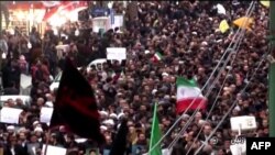 Islamic Republic of Iran Broadcasting shows Iranians chanting slogans as they march in support of the government in the northwestern city of Zanjan on January 1.