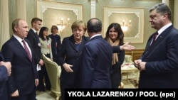 Встреча "Нормандской четверки" в Минске. Президент Украины Петр Порошенко, президент Франции Франсуа Олланд, канцлер Германии Ангела Меркель и президент России Владимир Путин. 11 февраля 2015 года.
