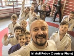 Тренер Михаил Петров в зале с детьми.