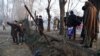 Afghan residents gather at the site of the January 4 suicide attack in Kabul.