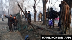 Afghan residents gather at the site of the January 4 suicide attack in Kabul.