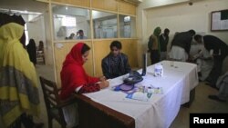 Pakistan -- A doctor writes a prescription for her patient at a hospital in Quetta, Balochistan, 14Dec2012
