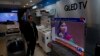 A Pakistani shopkeeper listens to Malala Yousafzai addressing a reception in Islamabad on March 29.