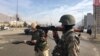 Afghan security personnel arrive at the site of a complex attack at an intelligence training center in Kabul on December 18.