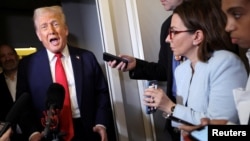 US President Donald Trump speaks to reporters on a flight to Washington on March 30.
