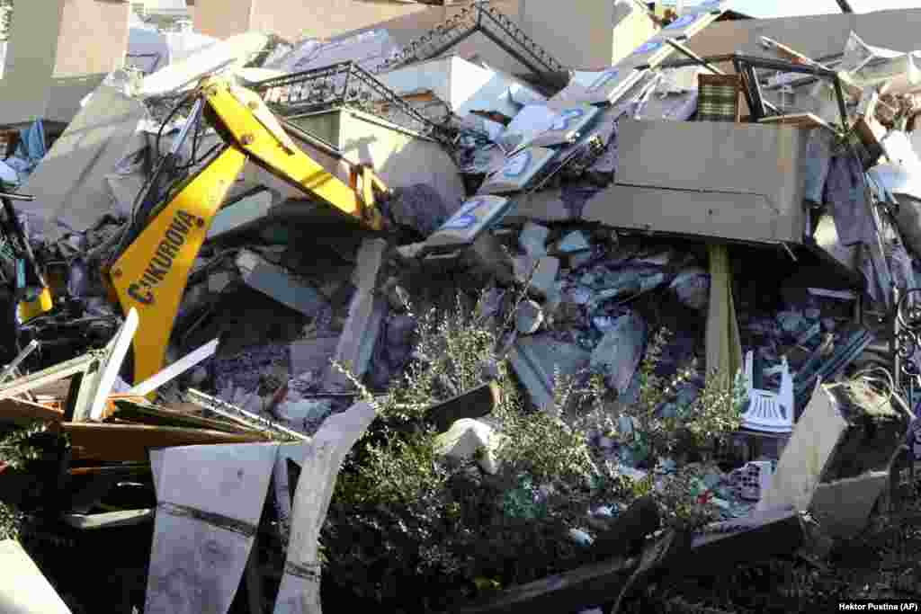 A crumpled building in the Adriatic port city of Durres, 30 kilometers west of the capital, as an excavator works to try to extract survivors. 