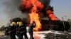 Afghan firefighters attempt to extinguish a burning fuel tanker which was hit by a magnetic bomb on the outskirts of the eastern city of Jalalabad on October 16.