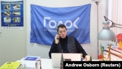 Golos co-Chairman Grigory Melkonyants speaks on the phone at his office in Moscow in 2018.