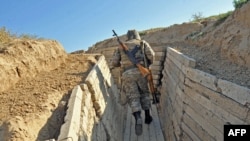 Nagorno-Karabakh -- An Armenian soldier of the self-proclaimed republic of Nagorno-Karabagh runs in trenches at the frontline on the border with Azerbaijan, 25Oct2012.