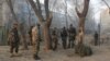 Afghan security forces inspect the site of a suicide attack in Kabul on January 5.
