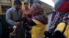 A health worker gives a polio vaccine to a child at a railway station, days after Pakistan launched an anti-polio campaign across the country, despite threats from the Taliban, in Karachi, Pakistan on Thursday, January 18.