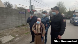 Пришедшая на пикет женщина попыталась пройти к зданию консульства, но путь ей перегородили сотрудники полиции. Алматы, 20 апреля 2021 года.