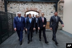 Ukrainian Foreign Minister Andriy Sybiha, US Secretary of State Marco Rubio, Turkish Foreign Minister Hakan Fidan, and Ukrainian Head of Presidential Office Andriy Yermak arrive for a meeting at Dolmabahce Palace in Istanbul on May 16.