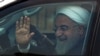 Iranian President Hassan Rohani waves to supporters after his arrival at Begumpet Airport in Hyderabad on February 15.